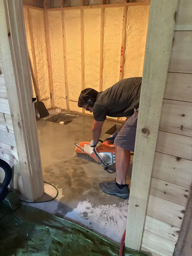 Blue Pacific technician cutting a concrete floor for new plumbing