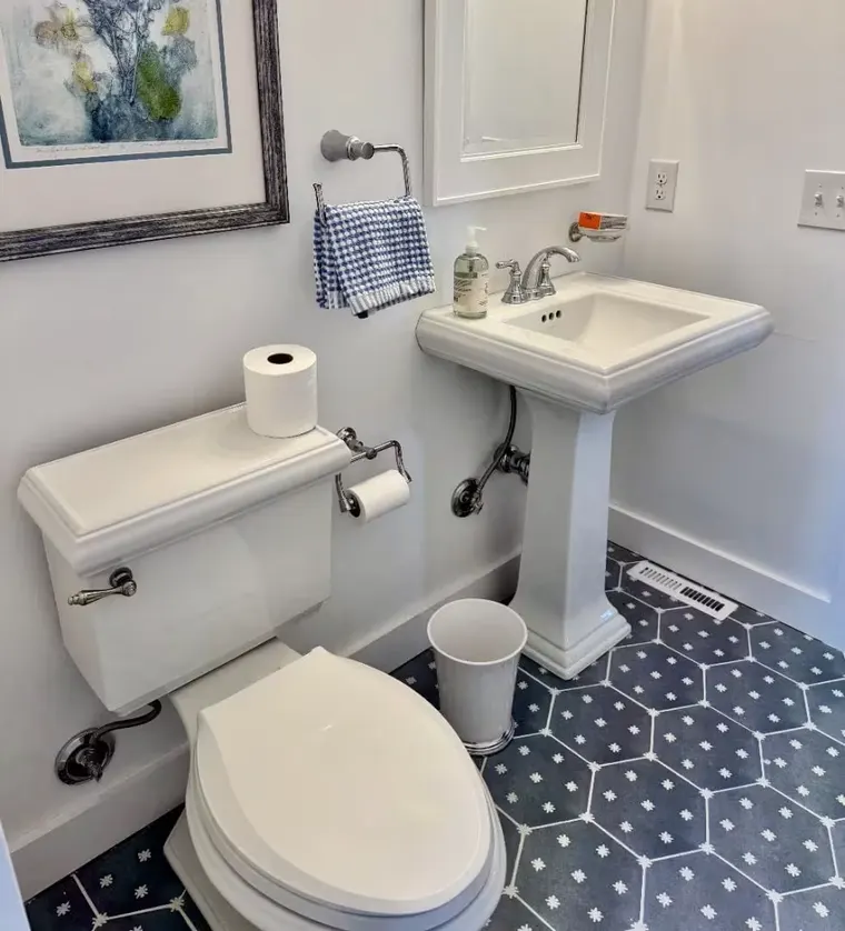 Bathroom with pedestal sink and new toilet
