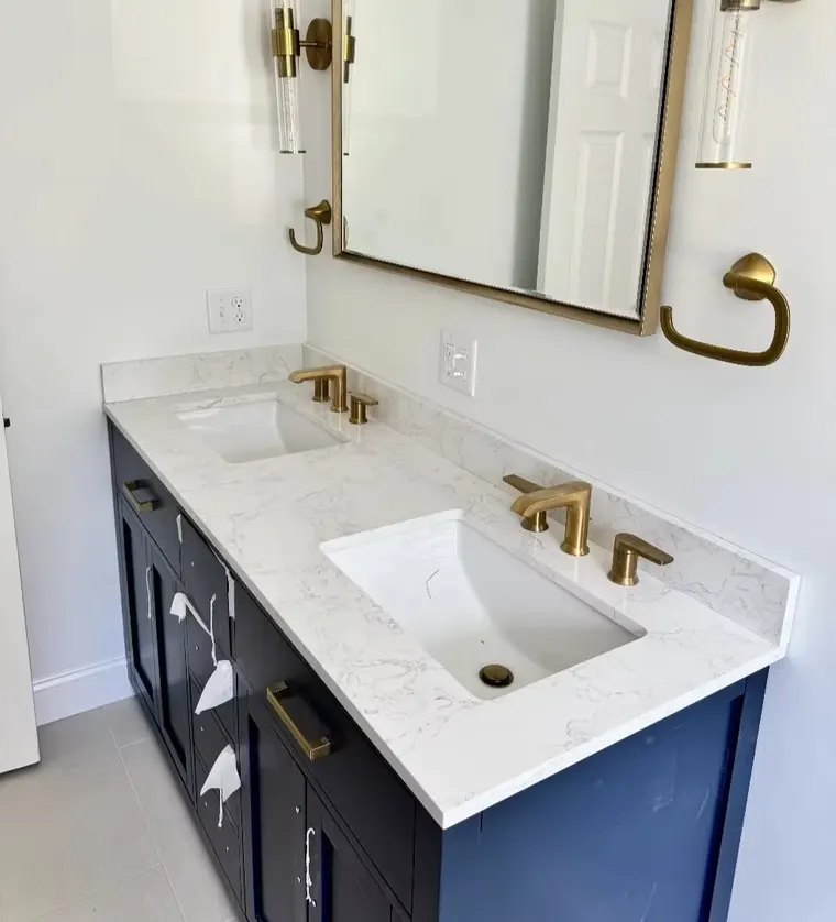 Double-sink vanity with brushed gold faucets